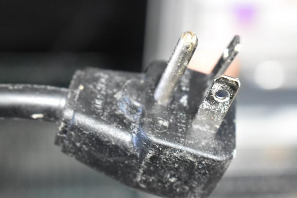 Close-up of a power plug for the 2022 Menumaster OC24HBK Commercial OnCue Microwave Oven.