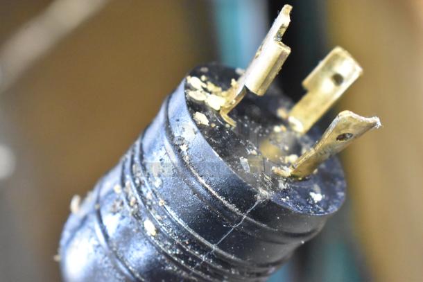 Close-up of a worn electrical plug of the AJ Antunes ES-1200 Egg Steamer, showing three prongs and visible wear.