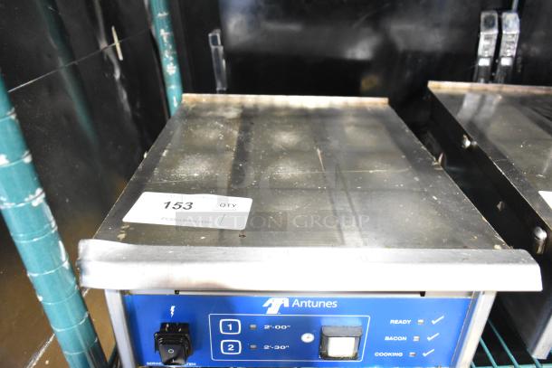 AJ Antunes ES-1200 countertop egg steamer, 208-240V, 1 phase. Features buttons for timing. Item tagged "153". Used condition.