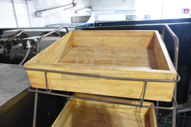 Two-tier wooden countertop merchandiser with metal frame, in good condition. Ideal for displaying products efficiently.