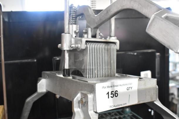 Countertop vegetable cutter with metal construction. Features sharp, parallel blades. Auction tag with lot number 156 visible.
