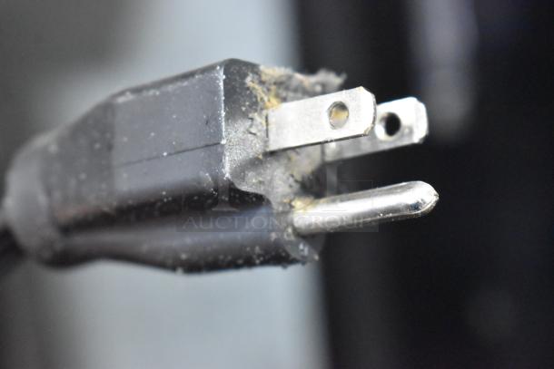 Close-up of a worn electrical plug for a Hoshizaki KM-515MWH Ice Maker, showing visible dust and wear on prongs.