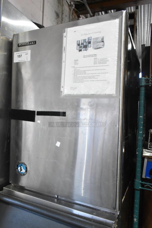Hoshizaki KM-515MWH commercial ice head on ice bin. Stainless steel, 115-120V, 1 phase. Cleaning instructions visible.