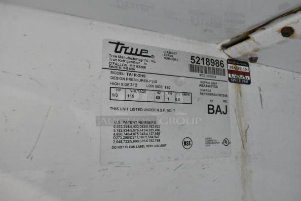 Label on a True TA1R-2HS Commercial Cooler showing model, voltage, and specs. Made in USA. NSF certified.