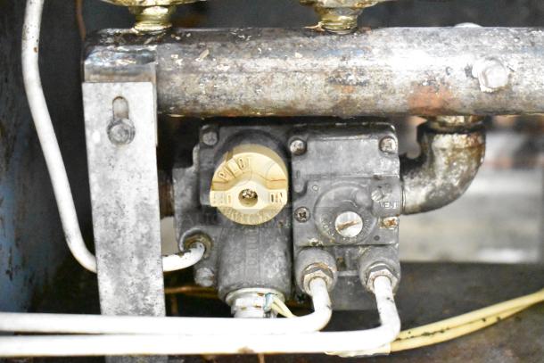 Pitco Frialator commercial gas deep fat fryer, showing control valve. Visible wear and connections; ideal for heavy-duty use.