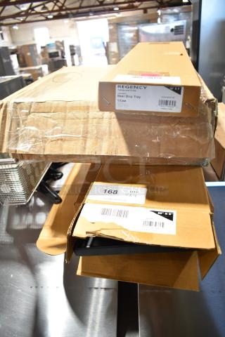 Boxes of new items, including Regency beer drip trays and scrubbing pads, labeled with auction details and scratch-and-dent condition.
