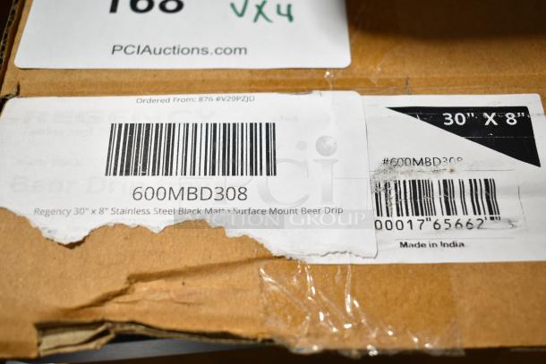 Cardboard box with labels showing Regency 30"x8" stainless steel black matte surface mount beer drip, model 600MBD308, made in India.