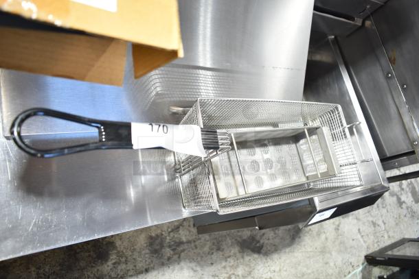 Brand new metal fry basket with a black handle, labeled with "170." Includes a table leg piece. Slight scratch and dent condition.