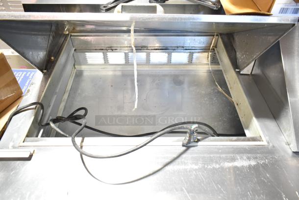 Beverage Air SPE60-24M commercial prep table; stainless steel, open interior, worn condition, on casters. 115V, 1 phase.