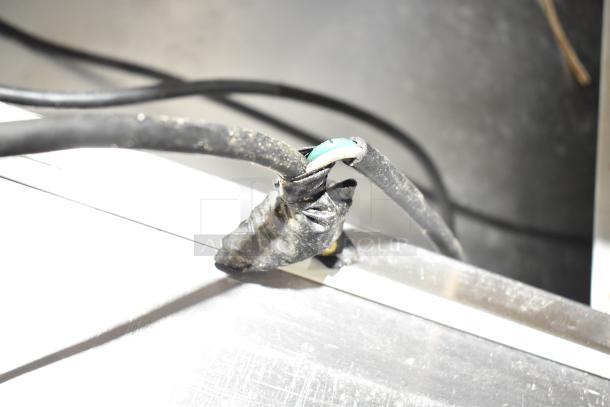 Electrical cord of Beverage Air SPE60-24M prep table showing signs of wear with visible wiring, indicating potential repair needed.