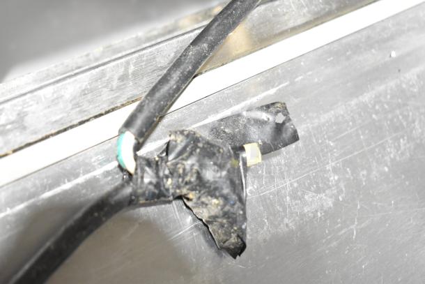 Beverage Air SPE60-24M prep table with visible electrical cord repair. Stainless steel top. 115 volts, 1 phase, on casters.