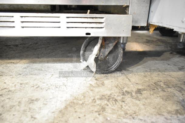 Beverage Air SPE60-24M prep table caster, showing visible rust and plastic debris. Model details: 115V, 1 Phase.