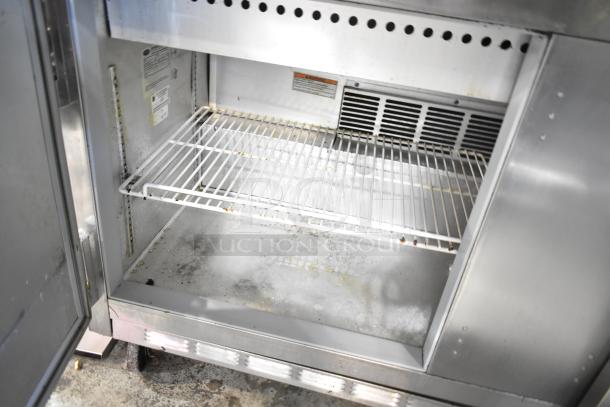 Beverage Air SPE60-24M prep table interior with wire shelf. Visible labels inside. Used condition. 115 volts, 1 phase.
