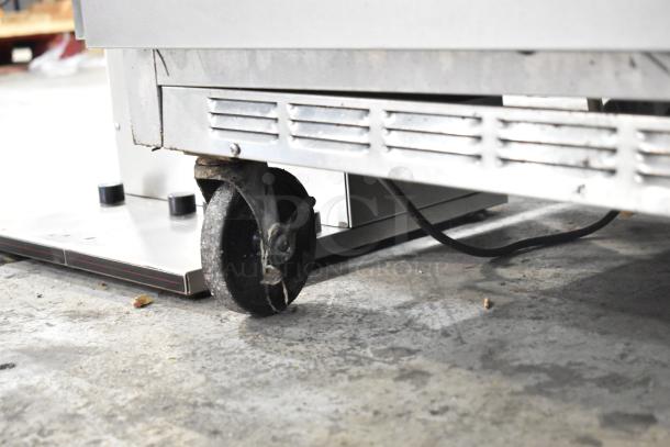 Beverage Air SPE60-24M prep table with commercial casters, visible lower section, used condition. 115V, 1 Phase.