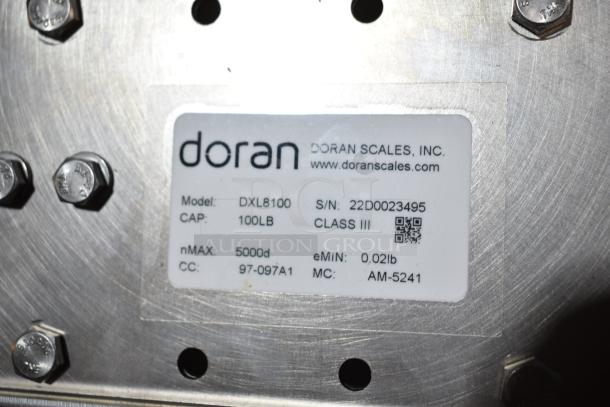 Doran DXL8100 Scale Base with 100lb capacity and serial number 22D0023495. Features include Class III, nMAX 5000d.