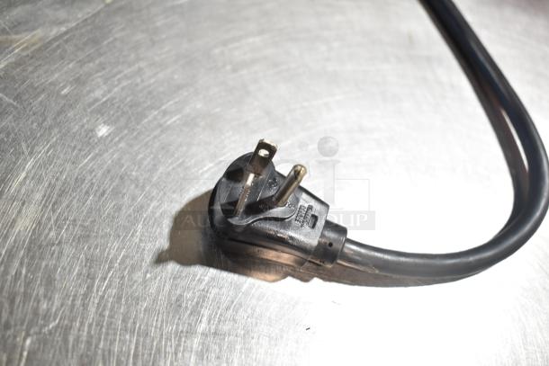 Close-up of a power plug for the 2023 Menumaster OC24HBK Commercial OnCue Microwave Oven, 208/240 Volts, 1 Phase.