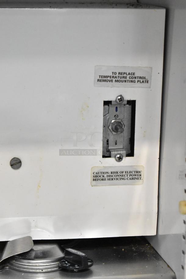 True TWT-72 Commercial 3 Door Work Top Cooler control panel with caution labels. 115 Volts, 1 Phase.