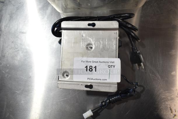 Lancer power supply and three food processor blades in a clear poly bin; auction label 181 visible.