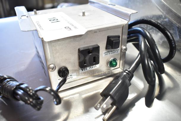 Metal Lancer power supply with switch, outlet, and cables. Includes label "QTY 181." Placed on a metal surface.