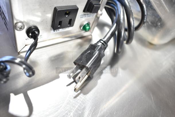 4 items including Lancer power supply and 3 food processor blades in clear poly bin. Good condition, visible cords and sockets.