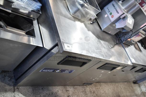 True TUC-48-LP commercial cooler with 2 door worktop, includes two Fetco beverage holders. Good condition, 115V, 1 phase.