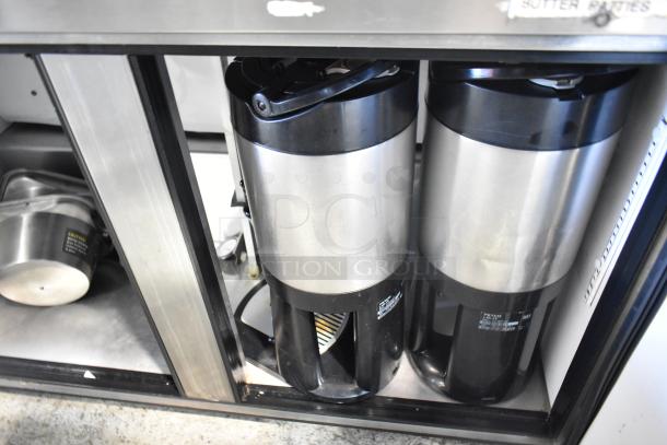 True TUC-48-LP cooler with two Fetco beverage dispensers, stainless steel, 115V, 1 phase, good condition.