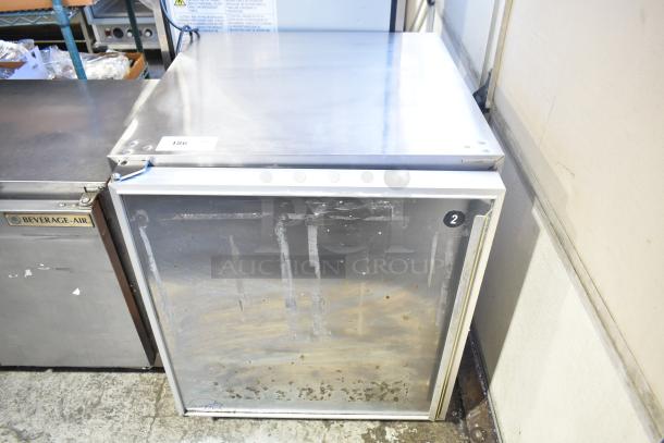 Silver King SKR27 single door undercounter cooler, used, stainless steel, visible wear marks, auction tag 186 attached.