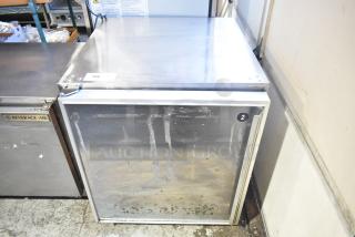 Silver King SKR27 single door undercounter cooler, used, stainless steel, visible wear marks, auction tag 186 attached.