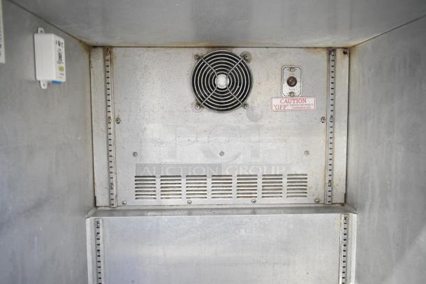 Silver King SKR27 undercounter cooler interior, featuring ventilation fan and caution label in fair condition.