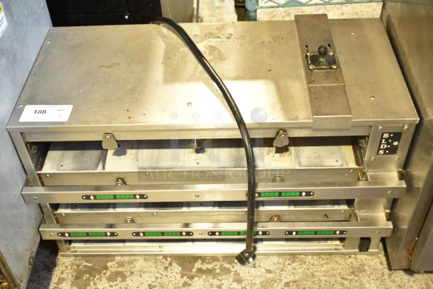 Commercial countertop dedicated holding bin in silver, featuring three adjustable shelves with temperature controls. Moderate wear visible.