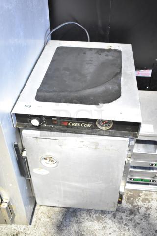 CresCor commercial heated holding cabinet on casters, 115 volts, 1 phase. Features dial control and temperature gauge. Visible wear.