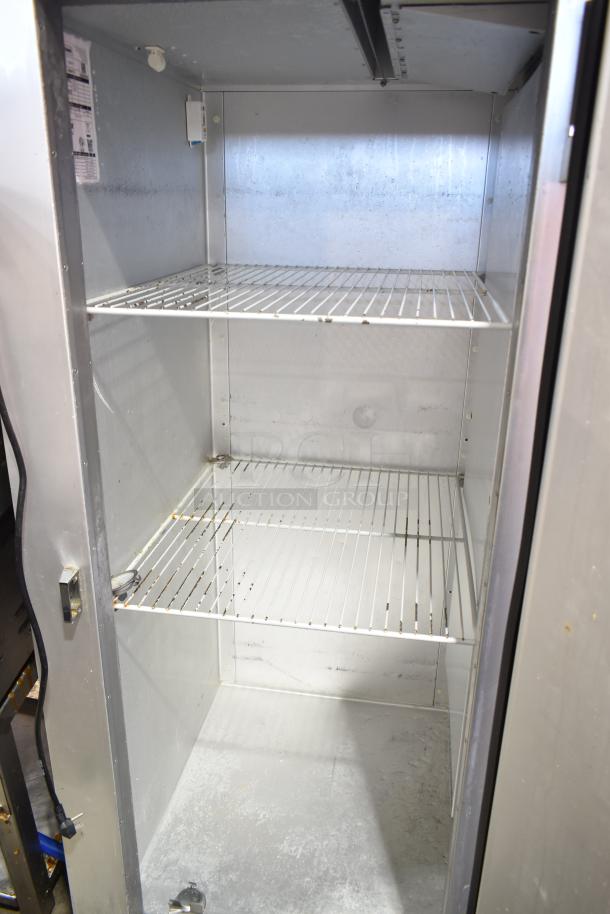 2022 Traulsen G12010 commercial freezer, single door, reach-in, on casters, 115V, 1 phase, clean interior with wire shelves.