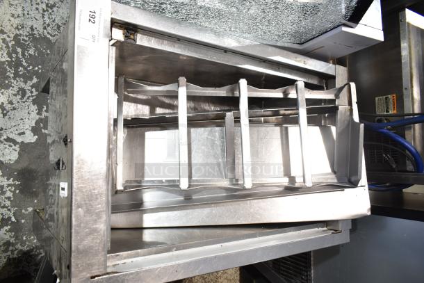 Stainless steel single well prep station on commercial casters, showing compartments and visible label indicating model 192. Slight wear.