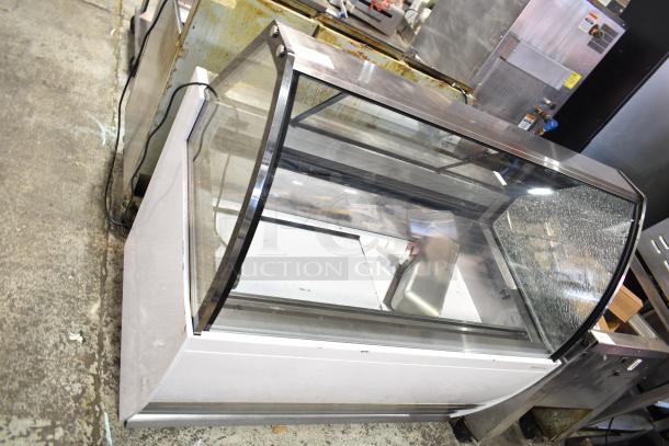 Commercial countertop merchandiser with visible glass damage, 115 volts, 1 phase.