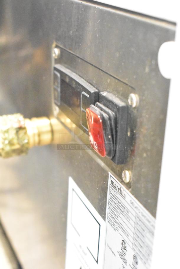 Commercial countertop merchandiser, Marchia brand, 115V, 1 phase. Visible glass damage. Control panel features on/off switch.