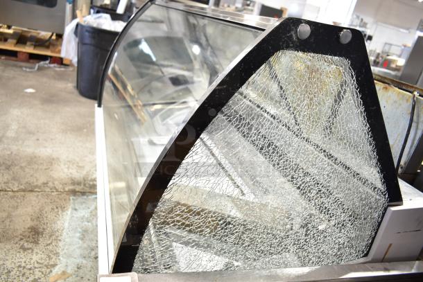 Commercial countertop merchandiser with shattered glass panel, 115 volts, 1 phase. Glass damage visible.