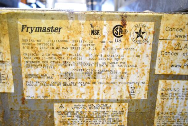 2023 Frymaster PH155CSE gas fryer label, showing model, 80,000 BTU, and installation info. Rust visible on surface.