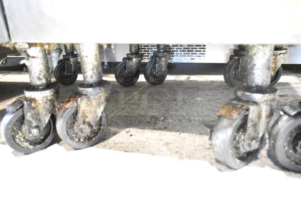 Casters on the Frymaster PH155CSE commercial gas fryer, showing wear. High efficiency, 80,000 BTU, 50 lb capacity.