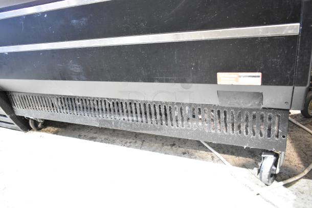 Turbo Air TOM-50B-N 50" vertical open air merchandiser with commercial casters, 115V, 1 Phase, visible wear on lower panel.