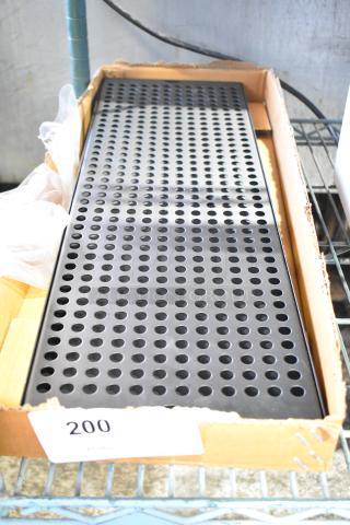 Brand new Regency 600MBD248 24" x 8" black matte surface-mount beer drip tray in original packaging with minor scratches.
