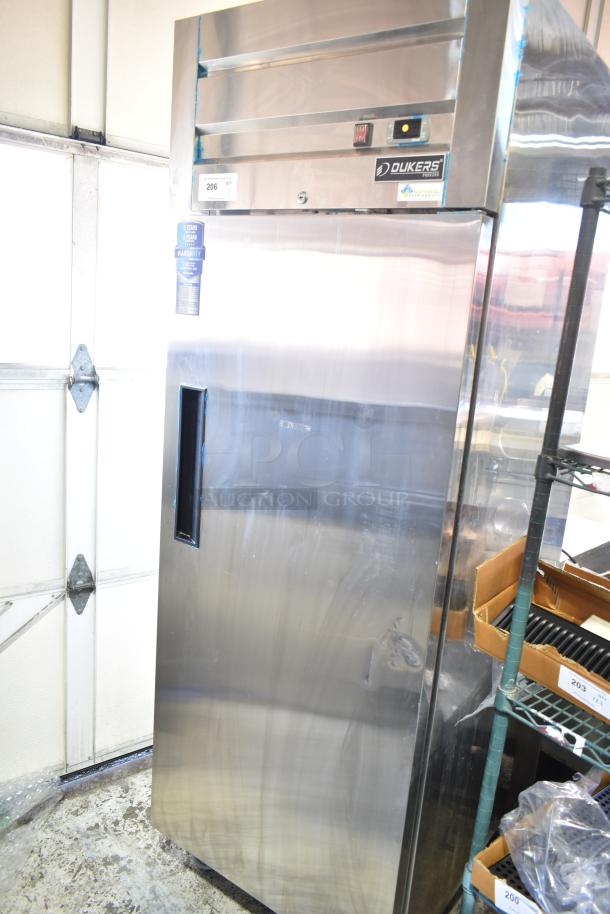 Dukers D28AF Commercial Single Door Reach-In Freezer, stainless steel, 115V, 1 Phase, on casters, with warranty tag visible.