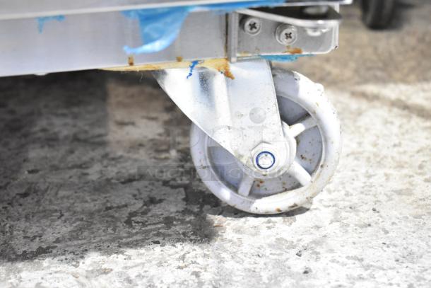 Close-up of a commercial caster on a Dukers D28AF single door reach-in freezer. Shows caster condition.