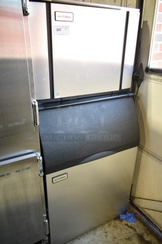 Ice-O-Matic commercial ice head on bin, stainless steel, visible brand label, minor surface wear.