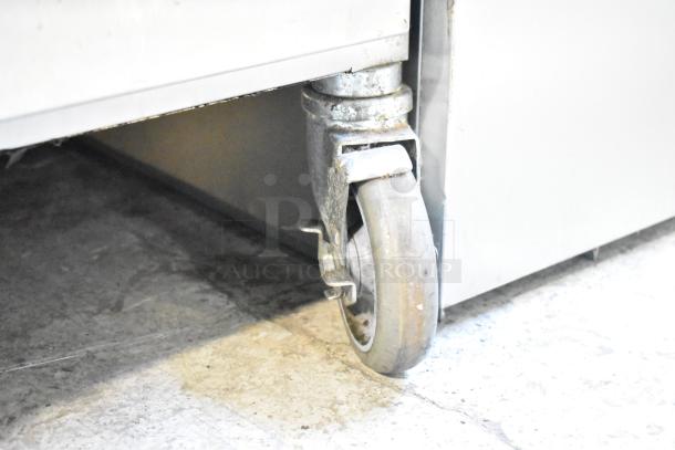 Alto Shaam Halo Heat heated holding cabinet caster detail, showing sturdy commercial wheel, slight wear on metal.