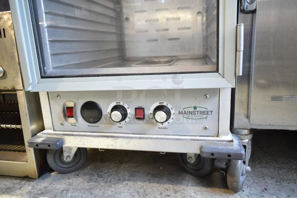 Mainstreet Commercial Heated Holding Cabinet, 115V, with casters. Features temperature, heat, and humidity controls, Mainstreet logo.