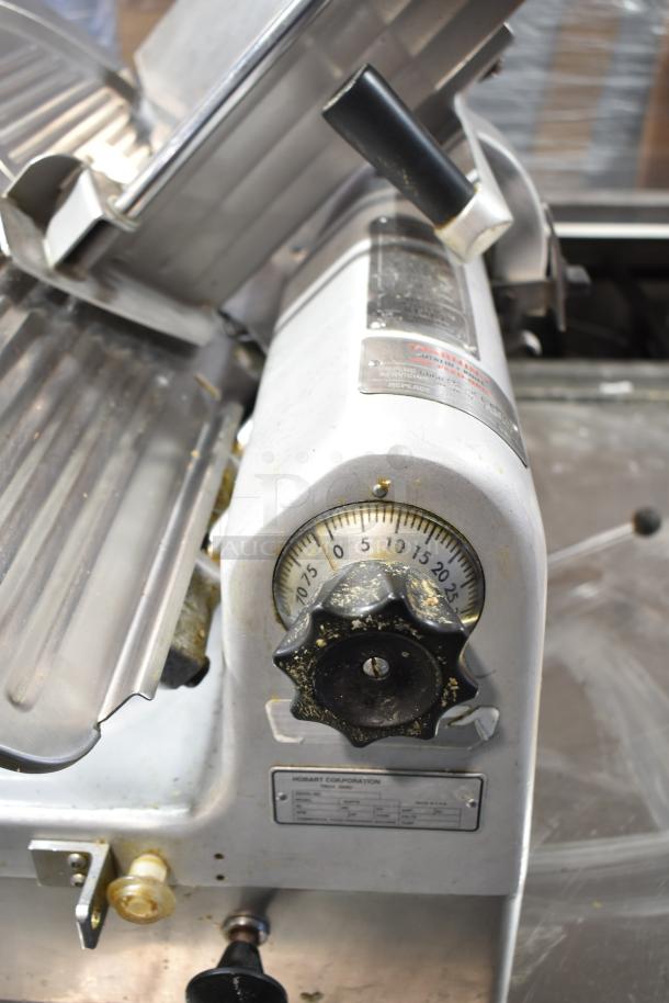 Hobart 1912 commercial meat slicer with blade sharpener, automatic function, 115 volts, 1 phase, visible labels and dials.