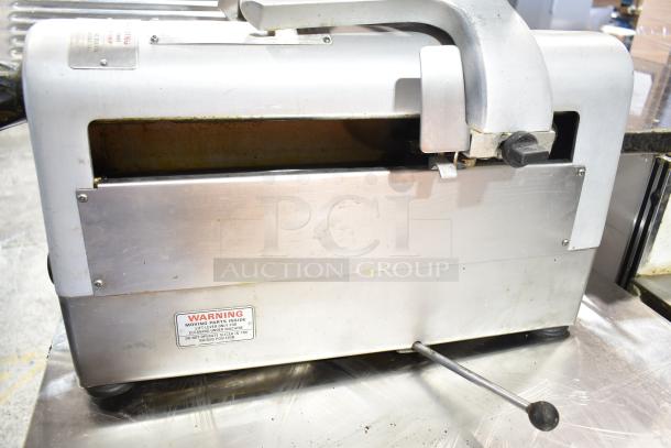 Hobart 1912 commercial meat slicer with automatic blade sharpener, 115 Volts, 1 Phase. Features warning label, in used condition.