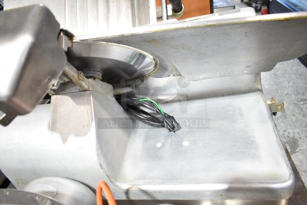 Hobart 1912 commercial meat slicer with blade sharpener, showing metal body, blade, and power cable. 115V, 1 phase.