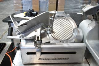 Globe Commercial Countertop Automatic Meat Slicer with blade sharpener, 115V, 1 phase. Features sturdy metal construction.
