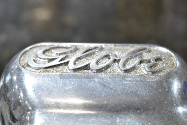 Globe logo on a commercial meat slicer, stainless steel finish, features blade sharpener; 115V, 1 Phase.